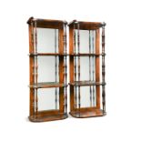 A pair of 19th century rosewood wall shelves, with mirrored backs, three quarter galleries and