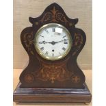 A Victorian rosewood mantel clock with marquetry inlay, the lancet top and waisted shaped case