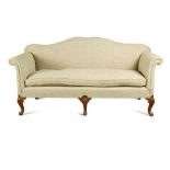 A 20th century George III style sofa, with a serpentine back, loose squab cushion seat, on scroll