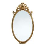 A mid-19th century oval gilt framed wall mirror, with pierced and carved rocaille cresting 113 x