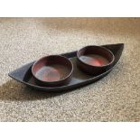 A Regency red lacquer coaster holder and coasters, the navette shape base containing a pair of