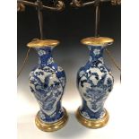 A pair of 19th century Chinese blue and white vases fitted as table lamps, painted with pheasants