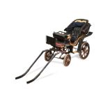 A Victorian child's four wheel dog/goat cart, the driver's seat flanked by a pair of carriage lamps,