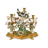 A decorative gilt bronze mounted porcelain candelabrum, the porcelain birds on boughs and