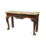 A George III Irish mahogany side table, the frieze carved in relief with shell, foliage, egg and