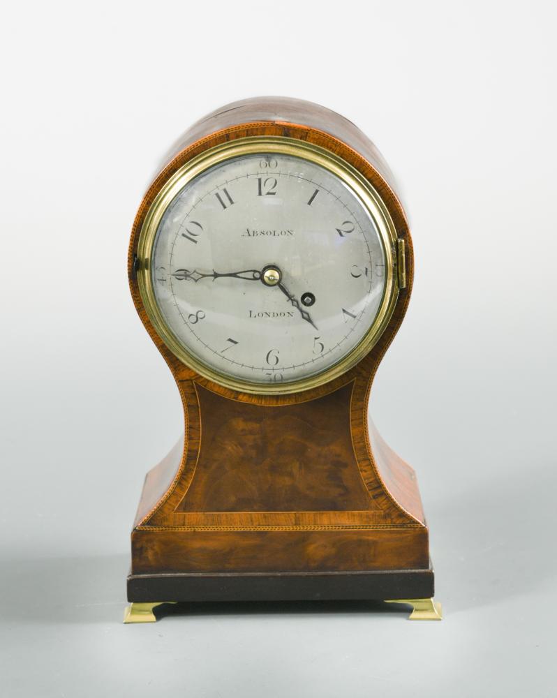 A Regency mahogany and cross-banded balloon mantel timepiece, the circular 4.5inch (11.5cm) silvered