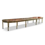 A 20th century Adam style mahogany D end dining table, in three sections with additional leaves, the