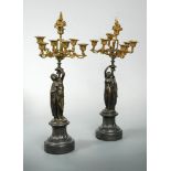 A pair of 19th century French bronze and parcel gilt six-branch seven-light table candelabra,