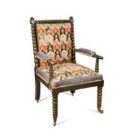 A William IV ebonised beech bobbin turned frame armchair, upholstered in a gross point needlepoint