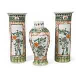 A garniture of three Chinese famille verte vases, Qing Dynasty, 19th century, comprising two