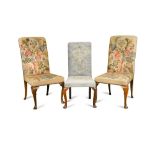 A pair of Queen Anne style walnut side chairs, with needlepoint upholstery on C scroll carved