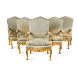 A set of six early 19th century German giltwood open armchairs, each with a shaped upholstered back,