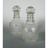 A pair of cut glass mallet shaped magnum decanters with later stoppers, with a broad band of diamond