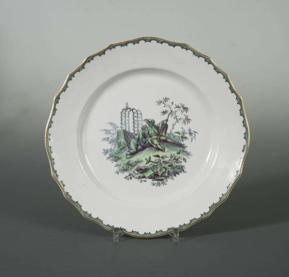 A Tournai plate, circa 1775, painted in camaieu verte with a central vignette of lovers in a