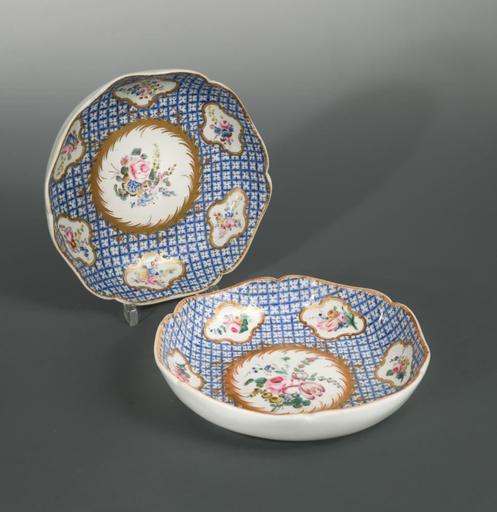 A pair of Chantilly saucer dishes, circa 1760, painted with scattered floral panels reserved on a