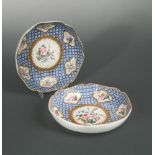 A pair of Chantilly saucer dishes, circa 1760, painted with scattered floral panels reserved on a