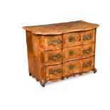 An early 18th century German walnut commode, of en arbalete outline and inlaid with the crest of a
