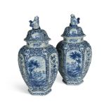 A pair of Dutch Delft blue and white vases and covers, 19th century, the ovoid hexagonal bodies