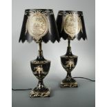 A pair of modern toleware table lamps and shades, the urn form bases decorated with foliate scrolls,