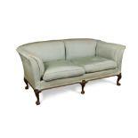 A George II style mahogany two seat sofa, raised on short cabriole legs and claw and ball feet,