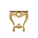 A George IV carved and pierced giltwood serpentine console in the manner of Thomas Johnson, with