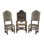 A 17th century Spanish walnut armchair, and two matching side chairs, with embossed leather brass