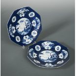 A pair of Bow blue octagonal plates, circa 1770, the central oval panels painted with river