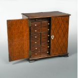 A 19th century marquetry inlaid oak table cabinet, the pair of doors opening to reveal a series of
