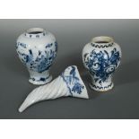 A Delft blue and white cornucopia wall pocket, the border moulded with foliage and centred with