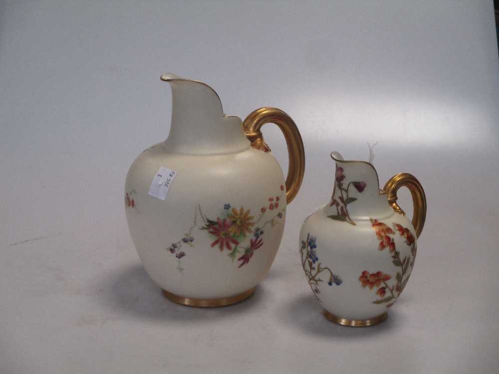 Two Royal Worcester floral ewers