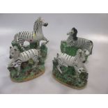 A pair of Staffordshire models of zebras; two other models of zebras (4)