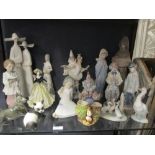 A collection of Lladro figures, including religious and clown figures etc