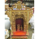 A carved giltwood Oriental shrine with small separate gilt figure and tablet