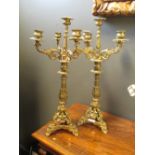 A pair of ornate brass candelabra (2)