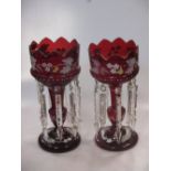 A pair of Victorian ruby glass lustres, enamelled with scrolling foliage, 34cm high; another