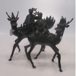 A pair of Chinese bronze figures, of men riding qilin, 36cm high overall, (2)