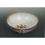 An 18th century Chinese famille rose export porcleain armorial punch bowl, the interior painted with