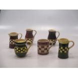 A collection of 19th century pottery jugs to include a canary ground jug, a mercury jug and