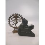 A metalwork figure of a deity together with an inuit carving