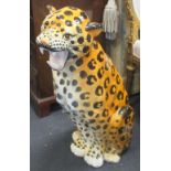 A large ceramic model of a seated leopard