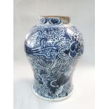 A blue and white baluster vase, late 18th century, painted with flowers and phoenixes, damaged