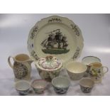 A Liverpool creamware plate. printed and painted with a ship; various creamware and pottery teabowls