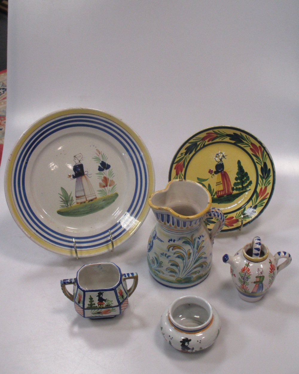 A group of Quimper/Rouen type pottery wares, various shapes and sizes, typical colours and