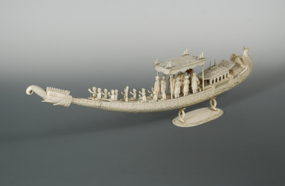 An Indian ivory carved model of a ceremonial boat, late 19th century, fitted with oarsmen rowing,