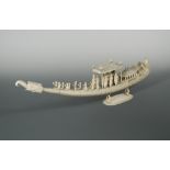 An Indian ivory carved model of a ceremonial boat, late 19th century, fitted with oarsmen rowing,