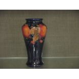A small Moorcroft vase decorated with pomegranates. the underside with impressed mark and