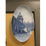 A pair of Continental porcelain blue and white oval plaques, one decorated with the 'Zwinger,