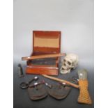 A skull, an axe, an oak writing box, a pewter figure, wooden marker, two horse shoes, various keys