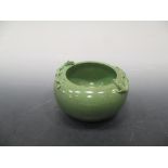 A Chinese porcelain powder green bowl, circular cushion form, the shoulders applied with two small