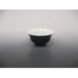 A Chinese porcelain blue monochrome bowl, Qing Dynasty, of ogee outline, with seal mark of the
